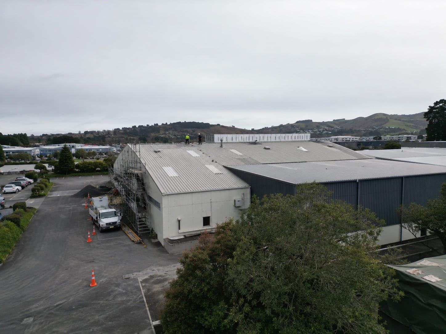 Commercial roofers working on a Whangarei warehouse roof