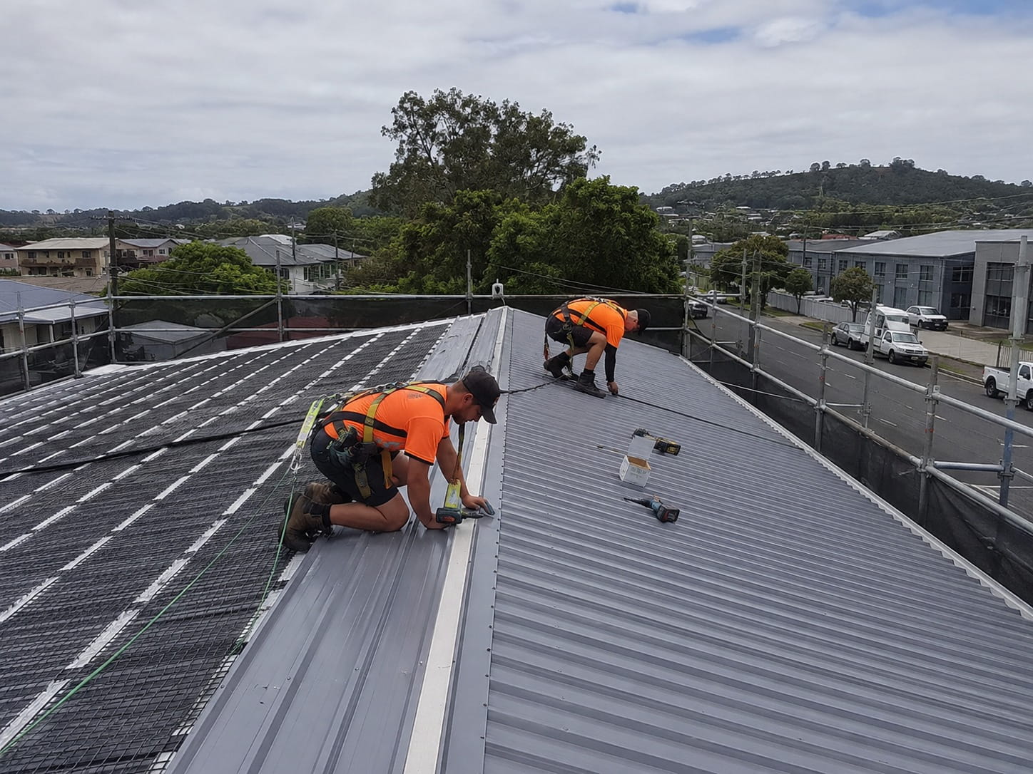 Commercial roofing crew installing long-run steel in Whangarei
