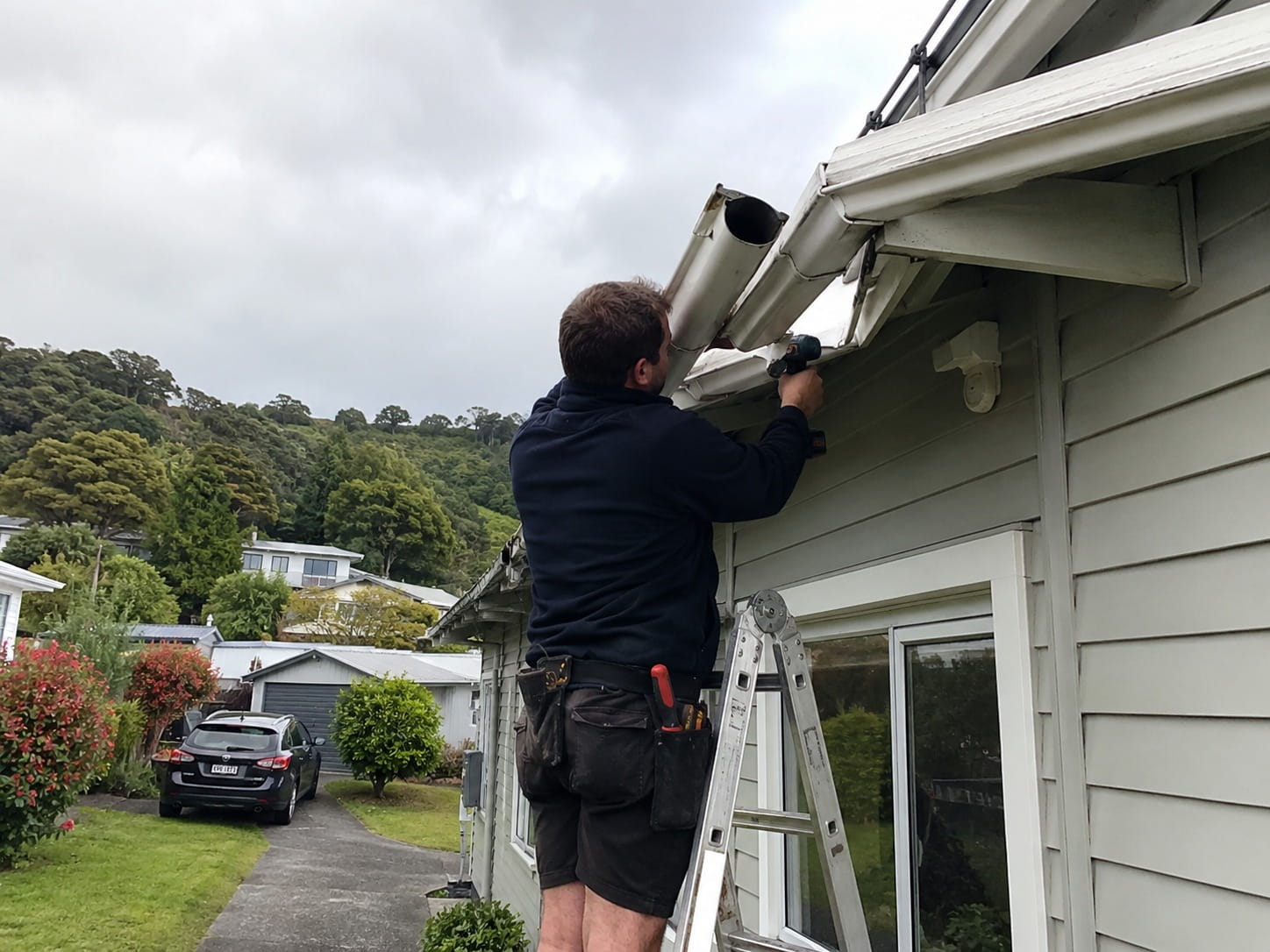 Roofer repairing spouting on a Whangarei home
